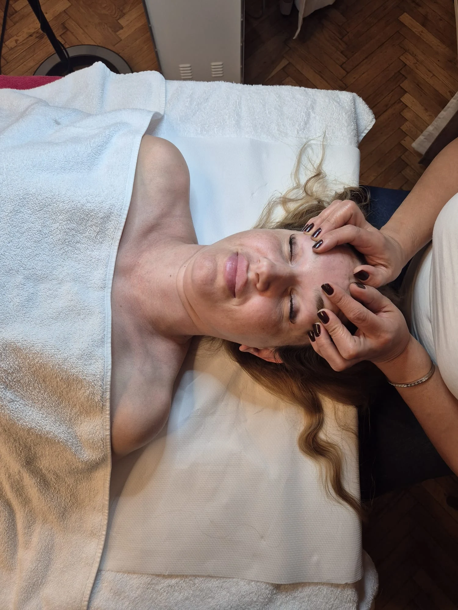 Masaj facial la Chic & GO, cu manevre de relaxare în zona frunții și tâmplelor